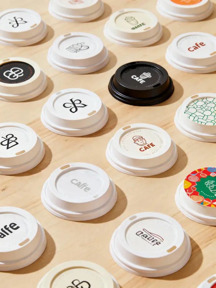 Diverse paper cup lids with pricing details.